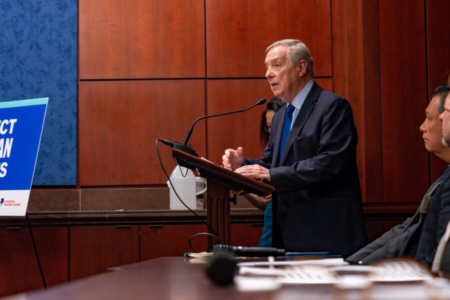 The image is of Senator Durbin at the press conference