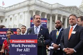 This image is of Chuy Garcia next to advocates holding signs in Washington D.C