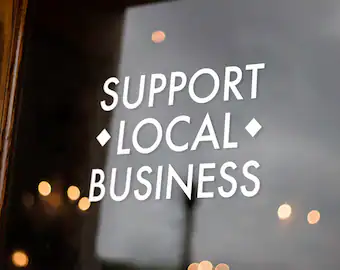 This image is a sign that reads, "Support Local Business"